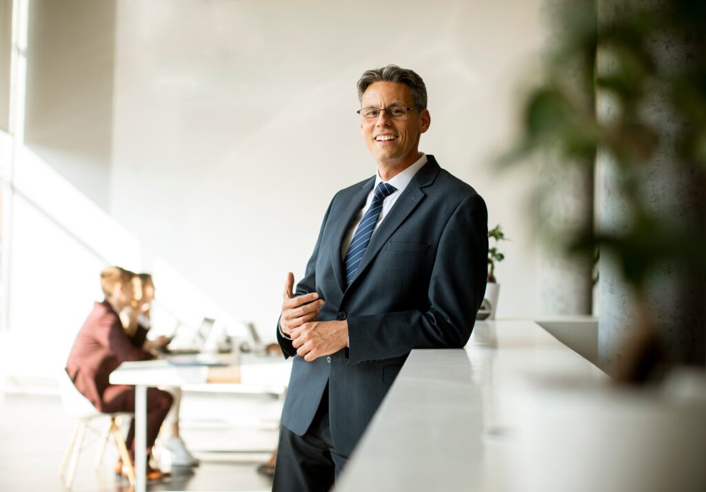 Handsome business man standing in the office